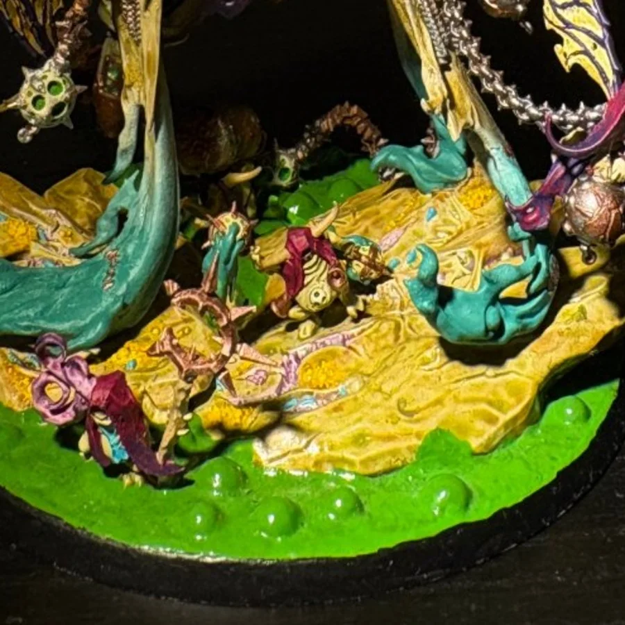 Close-up of a base diorama with fallen figures in acid