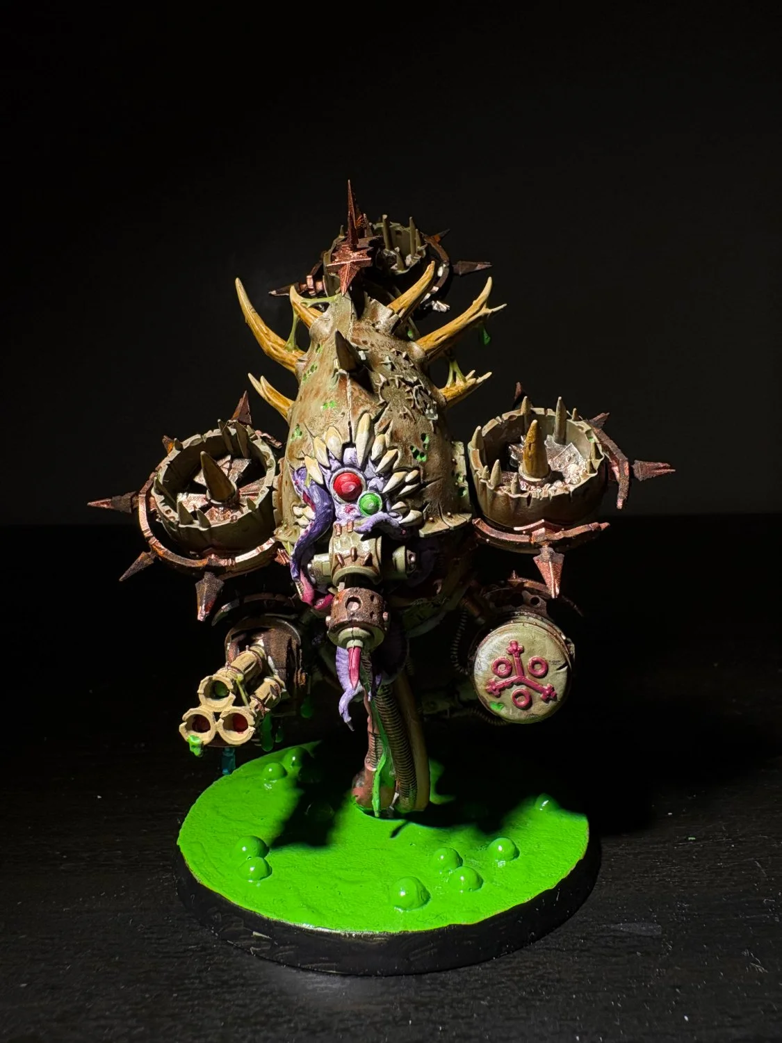 Spiked walker machine with cannon arms over green slime