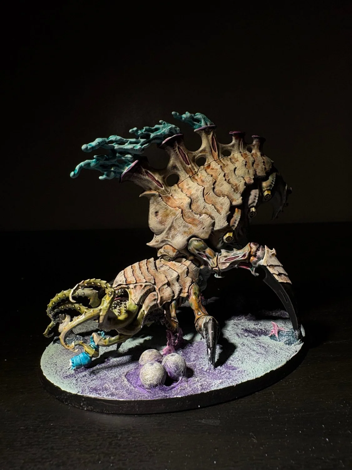 Heavy beast with teal flame growth standing over spent eggs